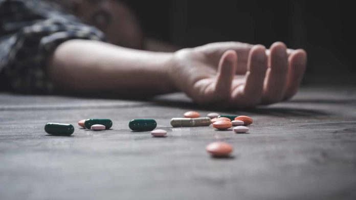The man committing suicide by overdosing on medication. Close up